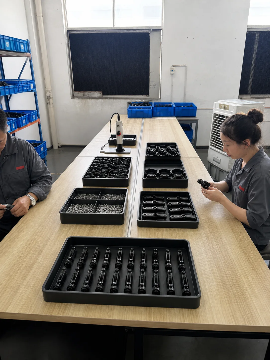 BENGGUO team performing final assembly at an organized workbench